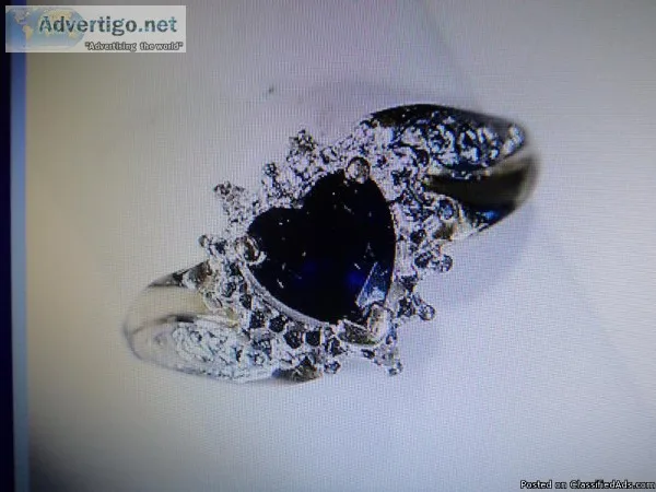 A VINTAGE Heart shaped Blue Sapphire Ring with Diamond Accents.