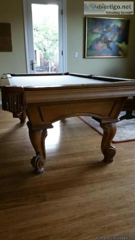 Pool table with pool sticks