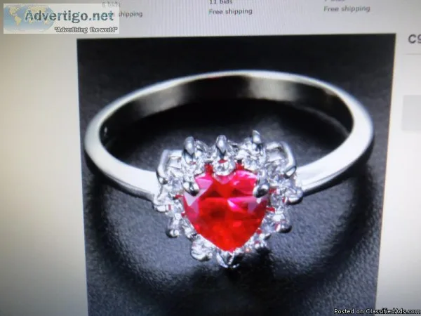 Heart Shaped Red Ruby Ring with White Topaz accents.