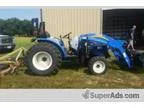 Brush hogging  4x4 tractor with front end loader and 5 ft brush 