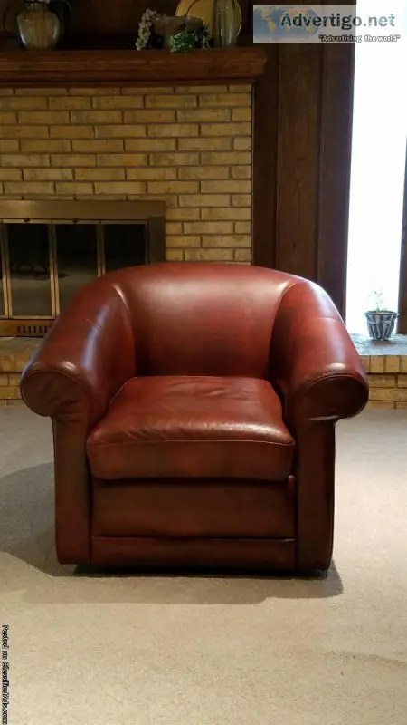 Two Leather Swivel Sofa Chairs
