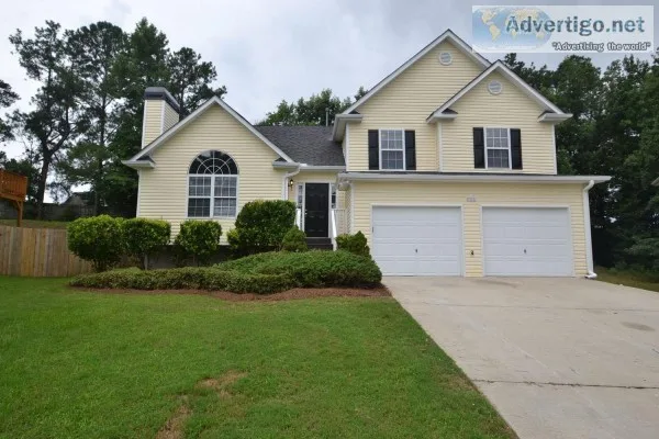 The home has a spacious outdoor living area with a wooden deck