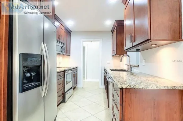 Kitchen in Cherry-wood cabinets and granite counters