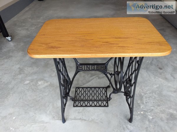 A sewing machine base with oak top