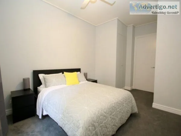 Spacious carpeted one bedroom with floor to ceiling built-in rob