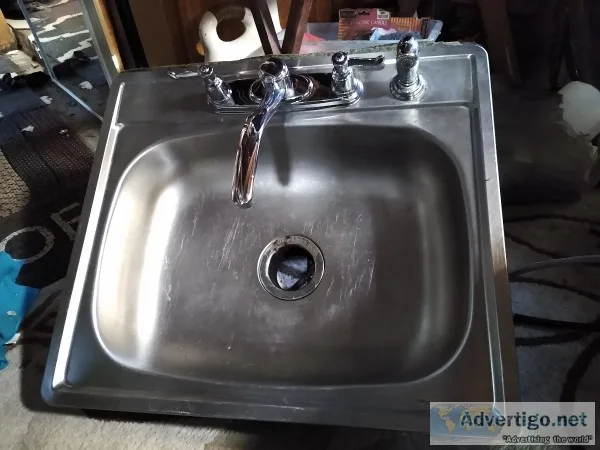 Stainless steel kitchen sink with Moen faucet
