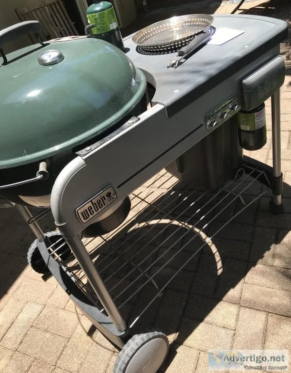 Large charcoal grill with a small propane tank to get the coals 