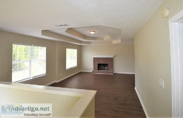 a fireplace in the living room and tile and carpet throughout th