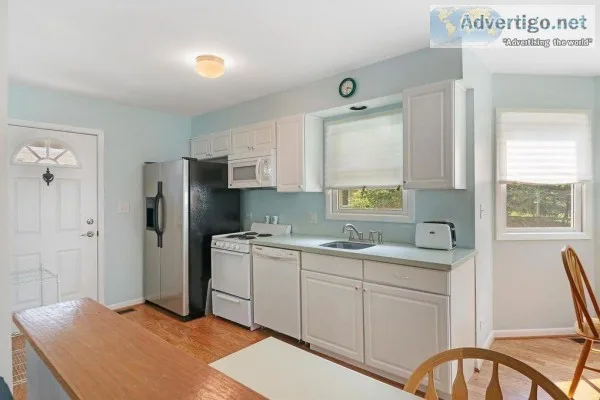 White Kitchen Cabinets With Corian Counter and Appliances