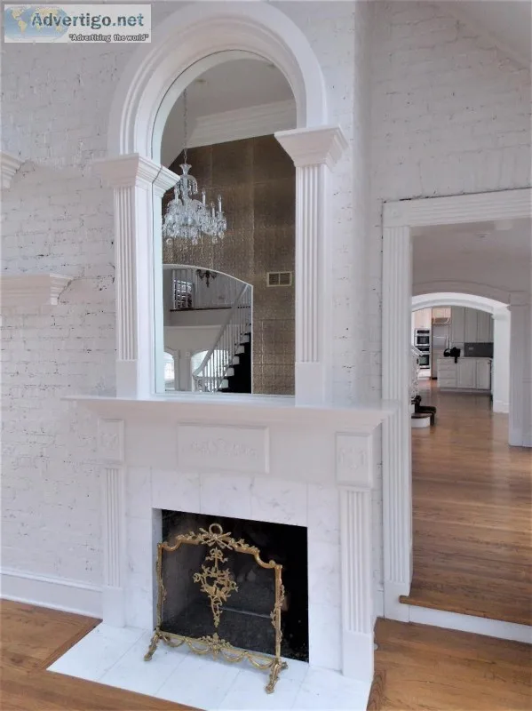 White Fireplace Mantel With Arched Mirror