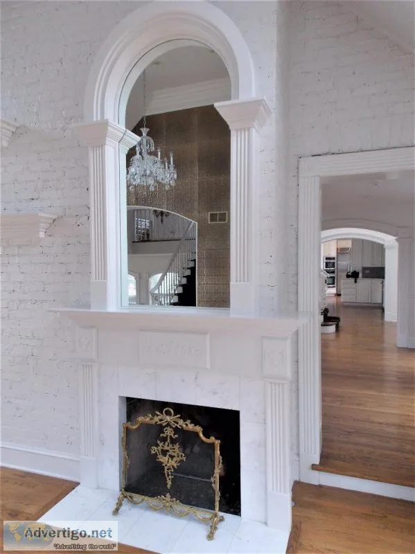 White Fireplace Mantel With Beautiful Arched Mirror