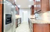 Kitchen in Cherry-wood cabinets and granite counters