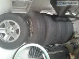 5 rims and tires for jeep 225 75 16 one tire is New rest not ver