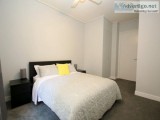 Spacious carpeted one bedroom with floor to ceiling built-in rob