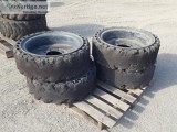 (4) RIMS WSOLID TIRES fits skidsteer