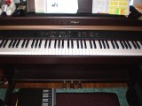 Roland HP107 Digital Piano home console style.