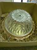 Beautiful crystal ceiling fixture with gold trim.