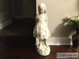 Statue Of Young Girl On Rock