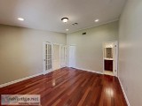 a covered porch entrance and a beautifully landscaped lawn