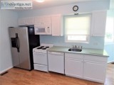 White Kitchen Cabinets With Corian Counter And All Appliances