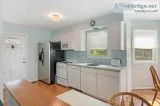 White Kitchen Cabinets With Corian Counter and Appliances