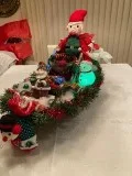 Big elf in sleigh with santa stocking holder and goodies