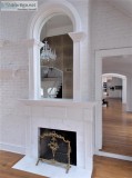 White Fireplace Mantel With Arched Mirror