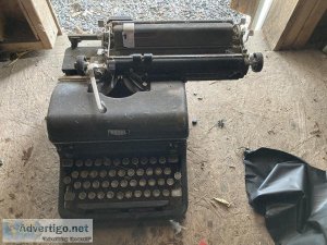 2 very old hand type writing machines.