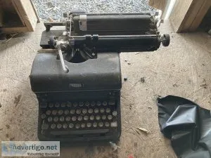2 very old hand type writing machines.