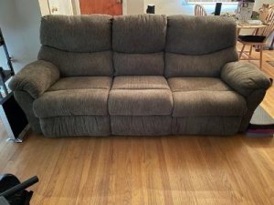 Reclining sofa with pull down console